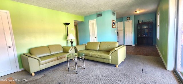 carpeted living room featuring a textured ceiling