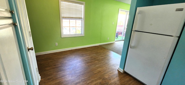 kitchen with white fridge and dark hardwood / wood-style flooring