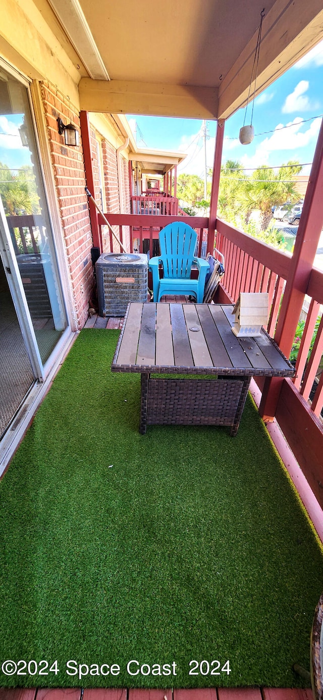 exterior space featuring a lawn and central air condition unit