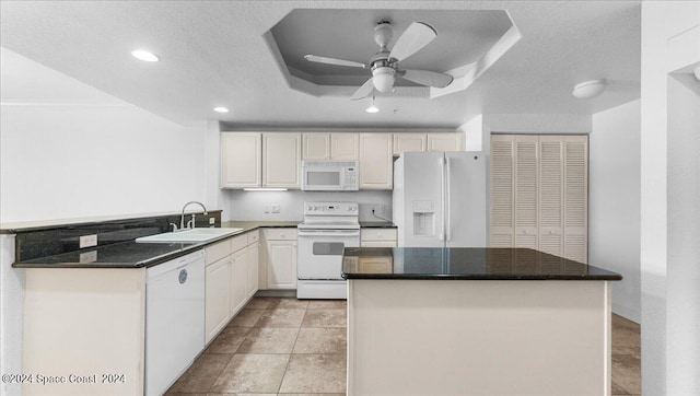 kitchen with white appliances, kitchen peninsula, a textured ceiling, ceiling fan, and sink