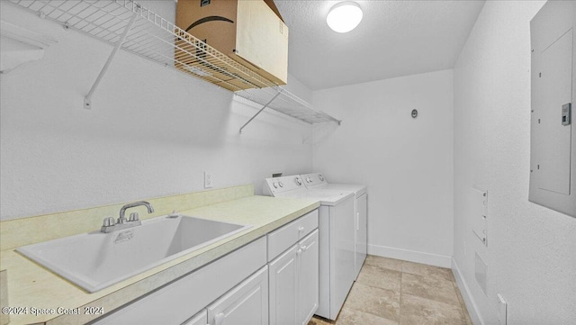 laundry area with washing machine and dryer, sink, and electric panel