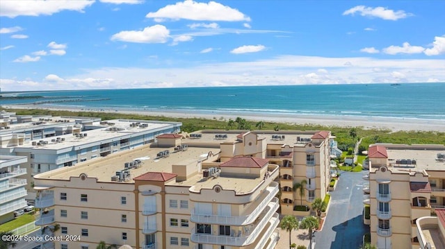 drone / aerial view featuring a water view and a beach view