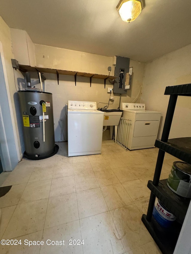 clothes washing area featuring washer and clothes dryer, electric water heater, electric panel, and sink