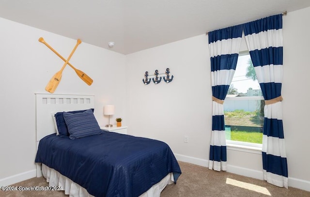 carpeted bedroom featuring multiple windows