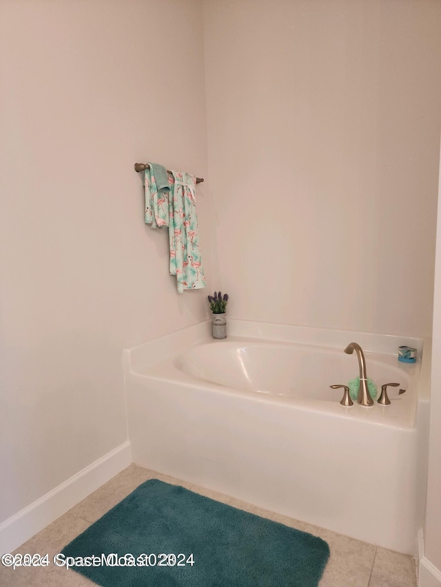 bathroom featuring a tub to relax in and tile patterned flooring