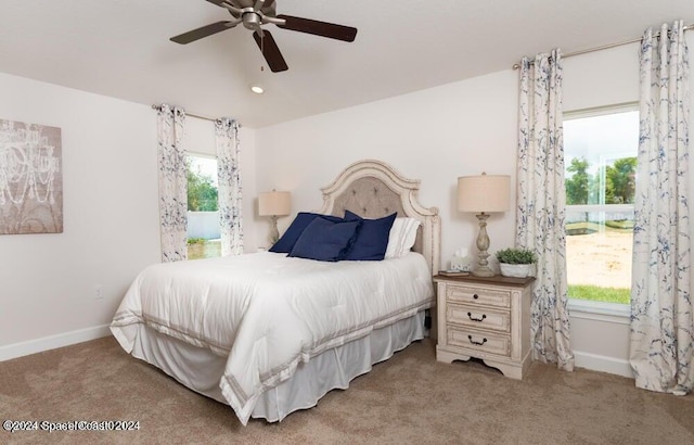 bedroom featuring multiple windows, carpet flooring, and ceiling fan