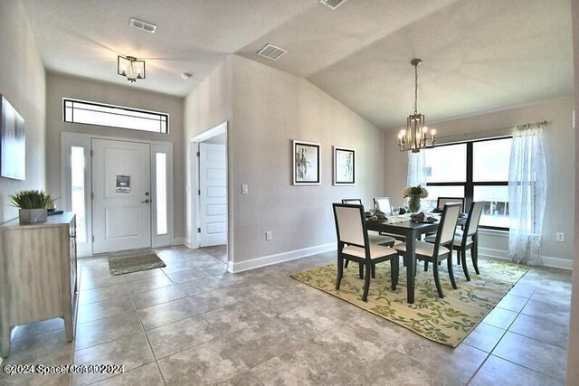 1182 Tupelo Cir, Cocoa, FL 32926 - dining room with a chandelier, baseboards, high vaulted ceiling, and light tile patterned floors
