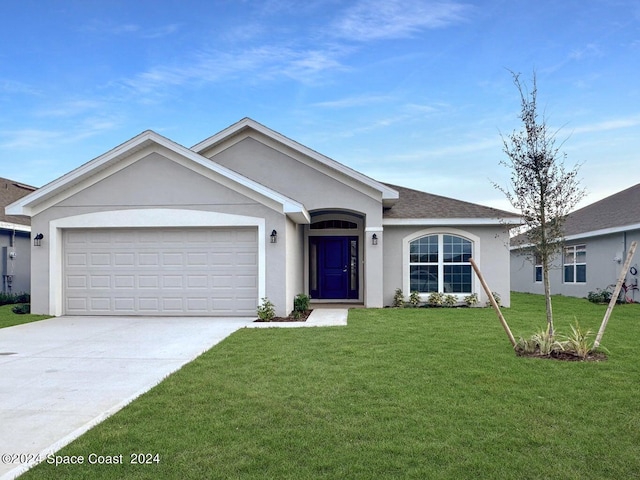 ranch-style house featuring a front yard and a garage