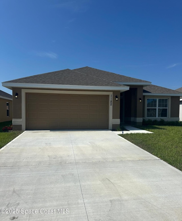 1182 Tupelo Cir, Cocoa, FL 32926 - ranch-style home with driveway, stucco siding, a garage, and a front yard
