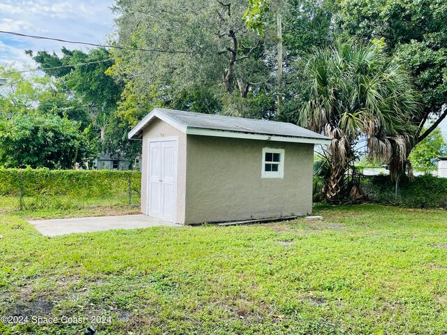 view of outdoor structure featuring a lawn