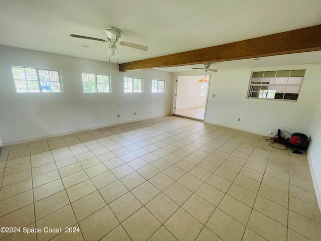 tiled spare room with beamed ceiling and ceiling fan