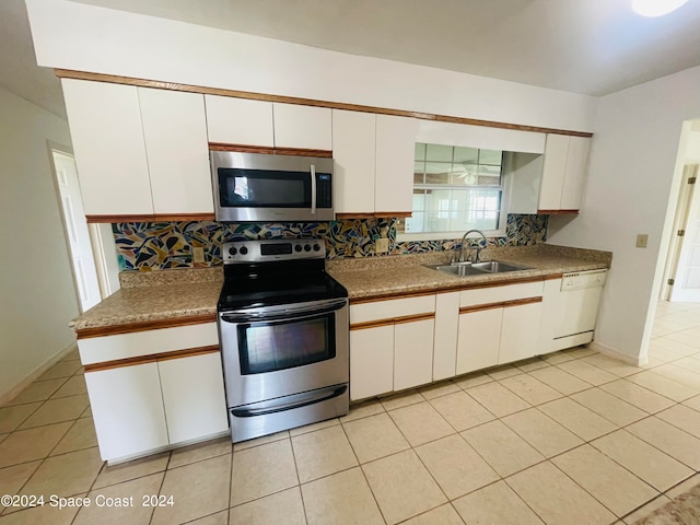 kitchen featuring white cabinets, appliances with stainless steel finishes, sink, and decorative backsplash