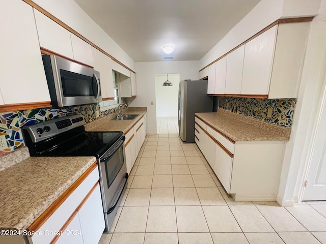 kitchen featuring backsplash, stainless steel appliances, white cabinetry, and sink