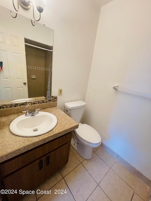 bathroom featuring vanity, toilet, a shower with shower curtain, and tile patterned floors