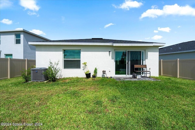 1447 Colebrook Cir SW, Palm Bay, FL 32908 - rear view of property featuring central AC, stucco siding, and a patio area