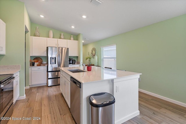 1447 Colebrook Cir SW, Palm Bay, FL 32908 - kitchen featuring stainless steel appliances, a sink, light wood-style flooring, white cabinetry, and recessed lighting