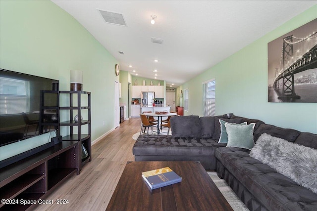 1447 Colebrook Cir SW, Palm Bay, FL 32908 - living room featuring vaulted ceiling, light wood-type flooring, baseboards, and recessed lighting