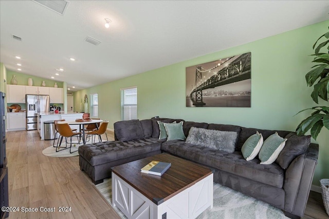 1447 Colebrook Cir SW, Palm Bay, FL 32908 - living room with light wood-style flooring and recessed lighting