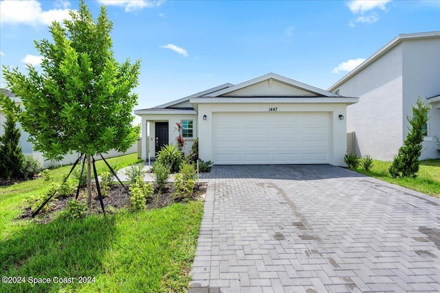 1447 Colebrook Cir SW, Palm Bay, FL 32908 - ranch-style house featuring stucco siding, decorative driveway, and an attached garage