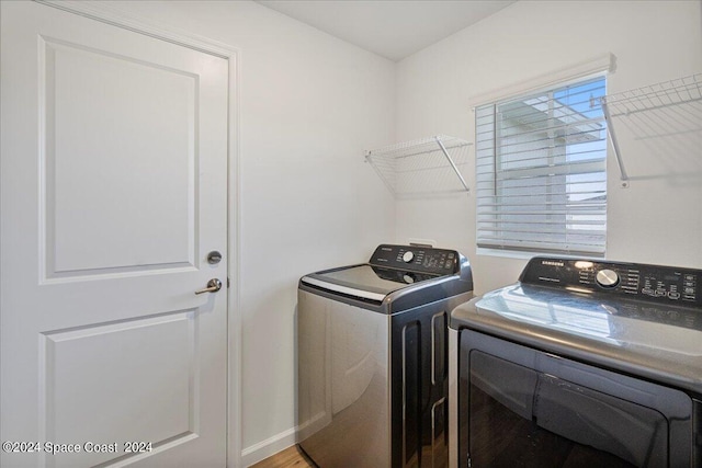 1447 Colebrook Cir SW, Palm Bay, FL 32908 - laundry room with washer and dryer, wood finished floors, and baseboards