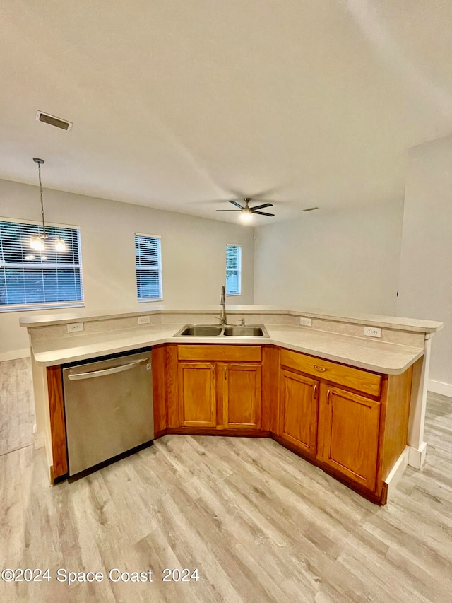 kitchen with sink, dishwasher, hanging light fixtures, ceiling fan, and light hardwood / wood-style flooring