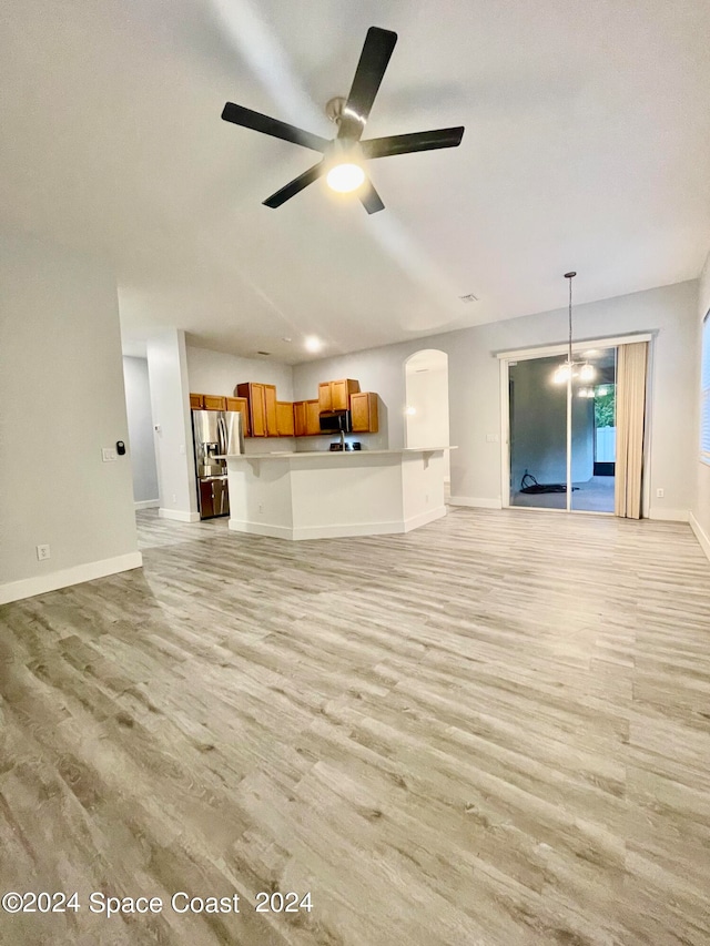 unfurnished living room featuring light wood-type flooring and ceiling fan