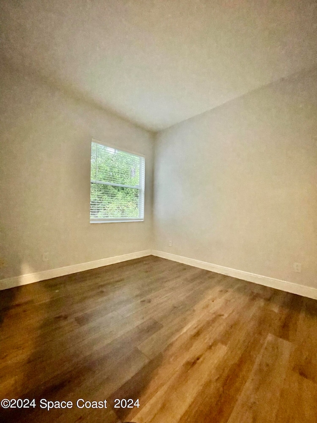 unfurnished room with hardwood / wood-style floors