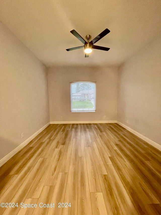 spare room with wood-type flooring and ceiling fan