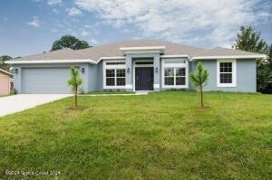 ranch-style home featuring a front yard and a garage