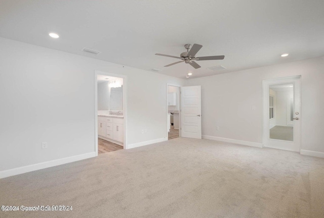 unfurnished bedroom with light colored carpet, baseboards, connected bathroom, and recessed lighting