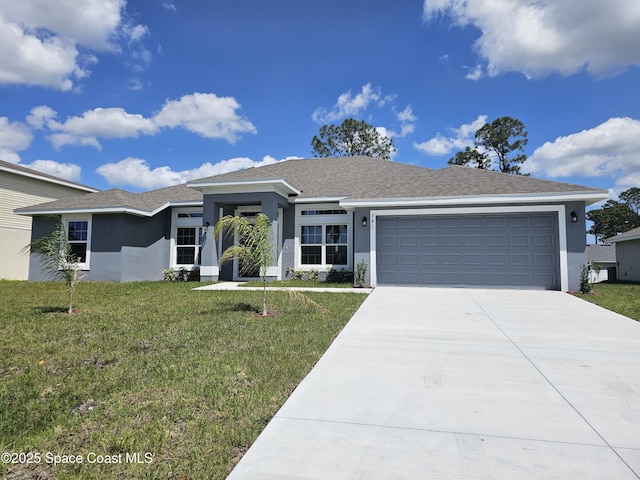 view of front of home with driveway, a front lawn, a garage, and stucco siding