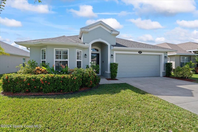 view of front facade featuring a front yard and a garage