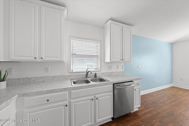 kitchen with stainless steel dishwasher, white cabinets, sink, and dark wood-type flooring