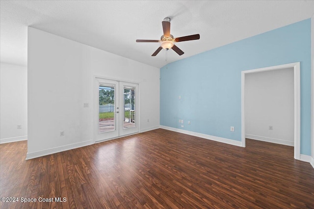 empty room with dark hardwood / wood-style floors, ceiling fan, lofted ceiling, and french doors