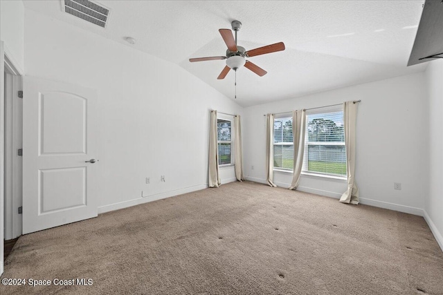 carpeted empty room with ceiling fan and lofted ceiling