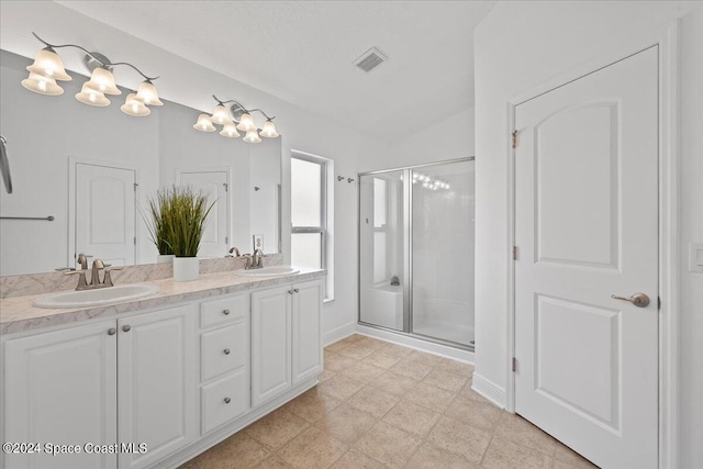 bathroom with vanity, vaulted ceiling, and an enclosed shower