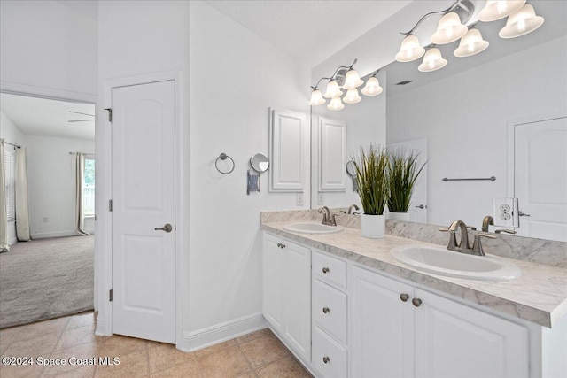 bathroom featuring vanity, ceiling fan with notable chandelier, and lofted ceiling