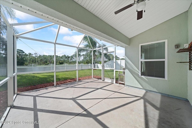 unfurnished sunroom with ceiling fan and vaulted ceiling