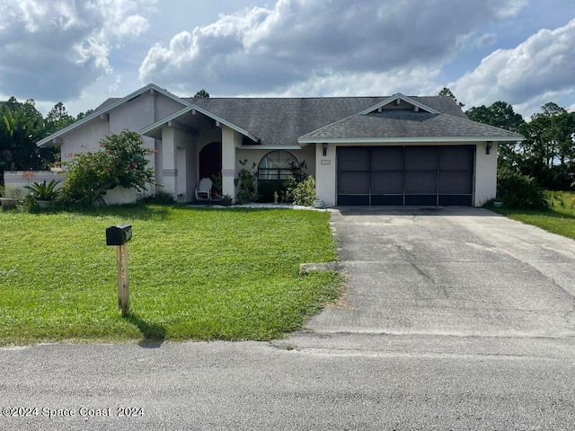 ranch-style home with a garage and a front lawn