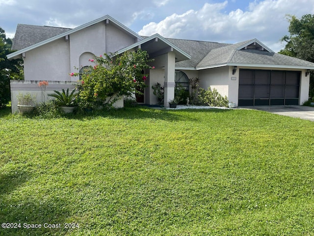 single story home with a garage and a front yard