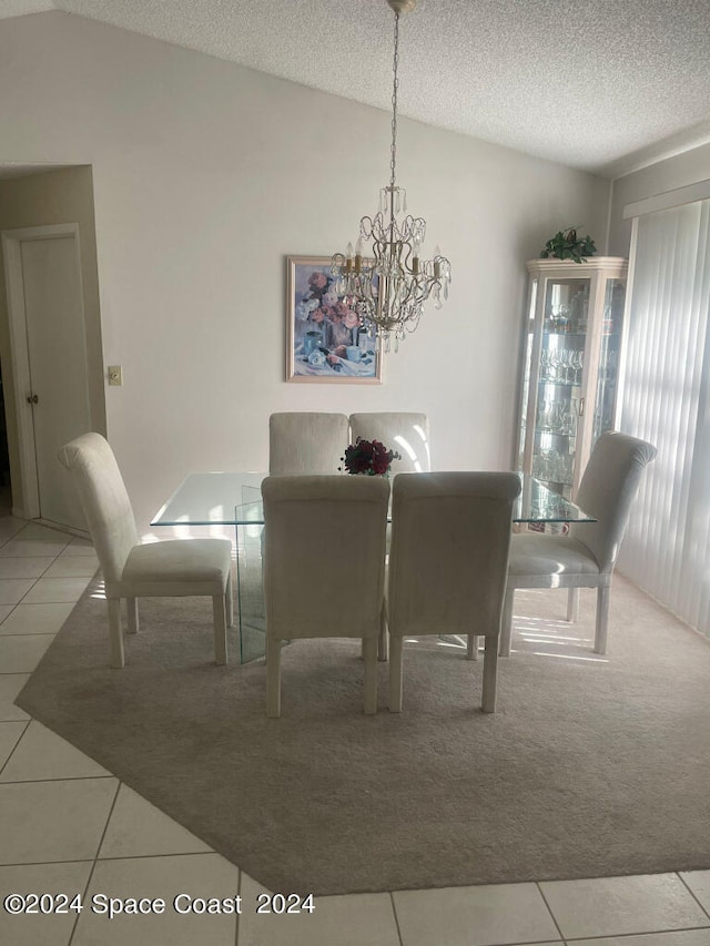 carpeted dining area with a textured ceiling, vaulted ceiling, and a notable chandelier