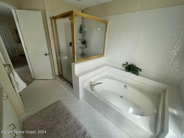 bathroom featuring shower with separate bathtub and tile patterned floors