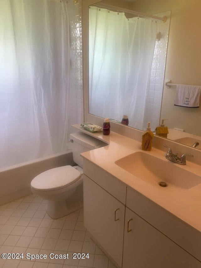 full bathroom with shower / bath combo, tile patterned flooring, vanity, and toilet