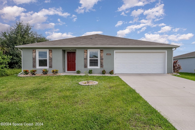 ranch-style home with a garage and a front lawn