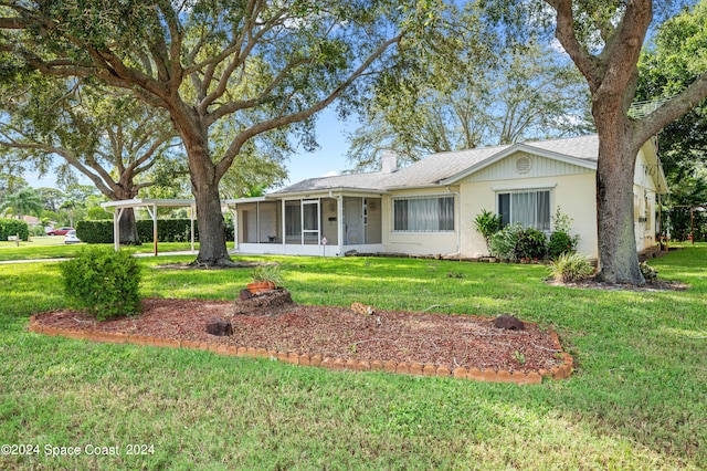 single story home featuring a sunroom and a front lawn