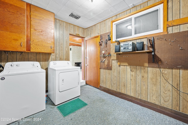 washroom with cabinets, wooden walls, and carpet