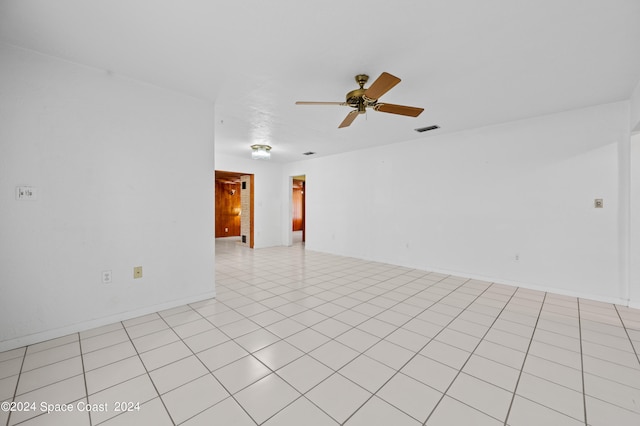 spare room featuring ceiling fan and light tile patterned floors