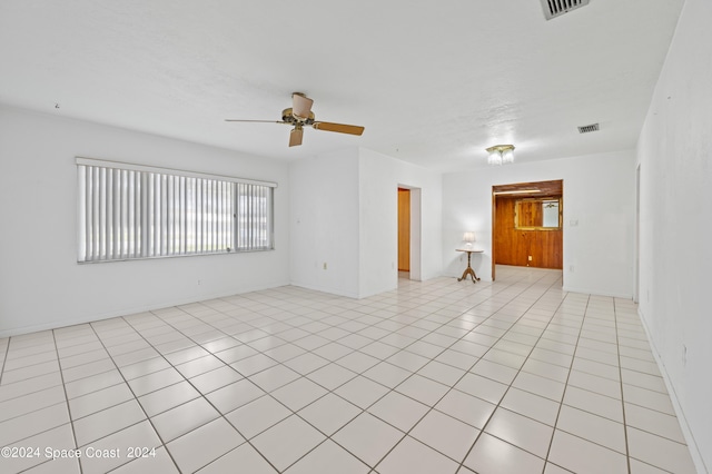 unfurnished room featuring ceiling fan and light tile patterned flooring