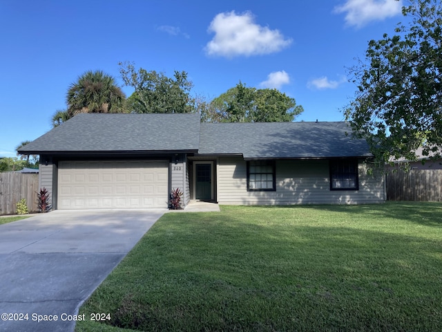 single story home with a garage and a front lawn