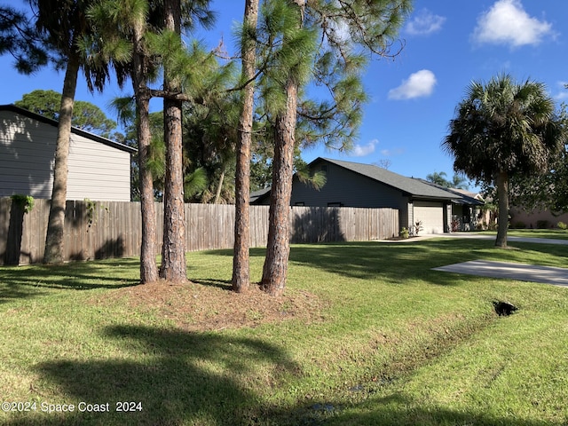 view of side of property with a yard